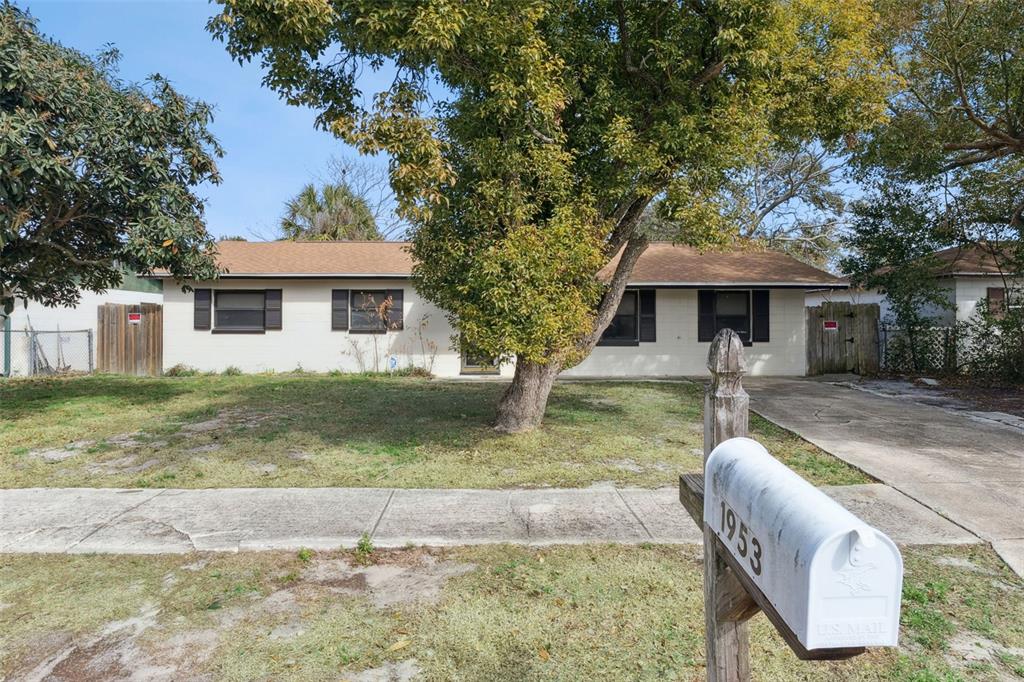 A single-story house with a light-colored exterior, a brown roof, and a front yard — 1953 LINDA AVENUE, ORMOND BEACH, FL