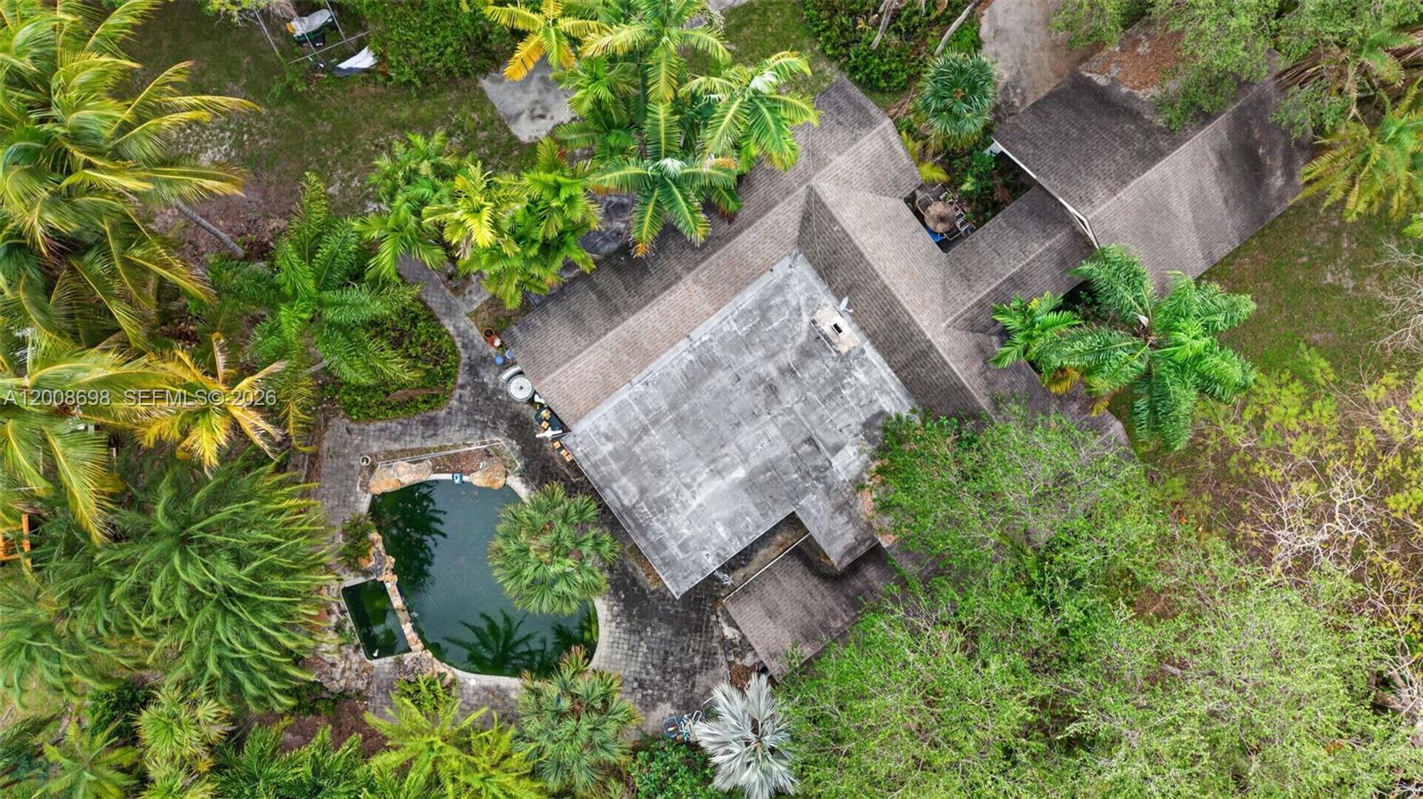 An aerial view shows a house with a flat roof, a pool, and surrounding palm trees — 8339 SW 112th St, Miami FL 33156, MIAMI, FL