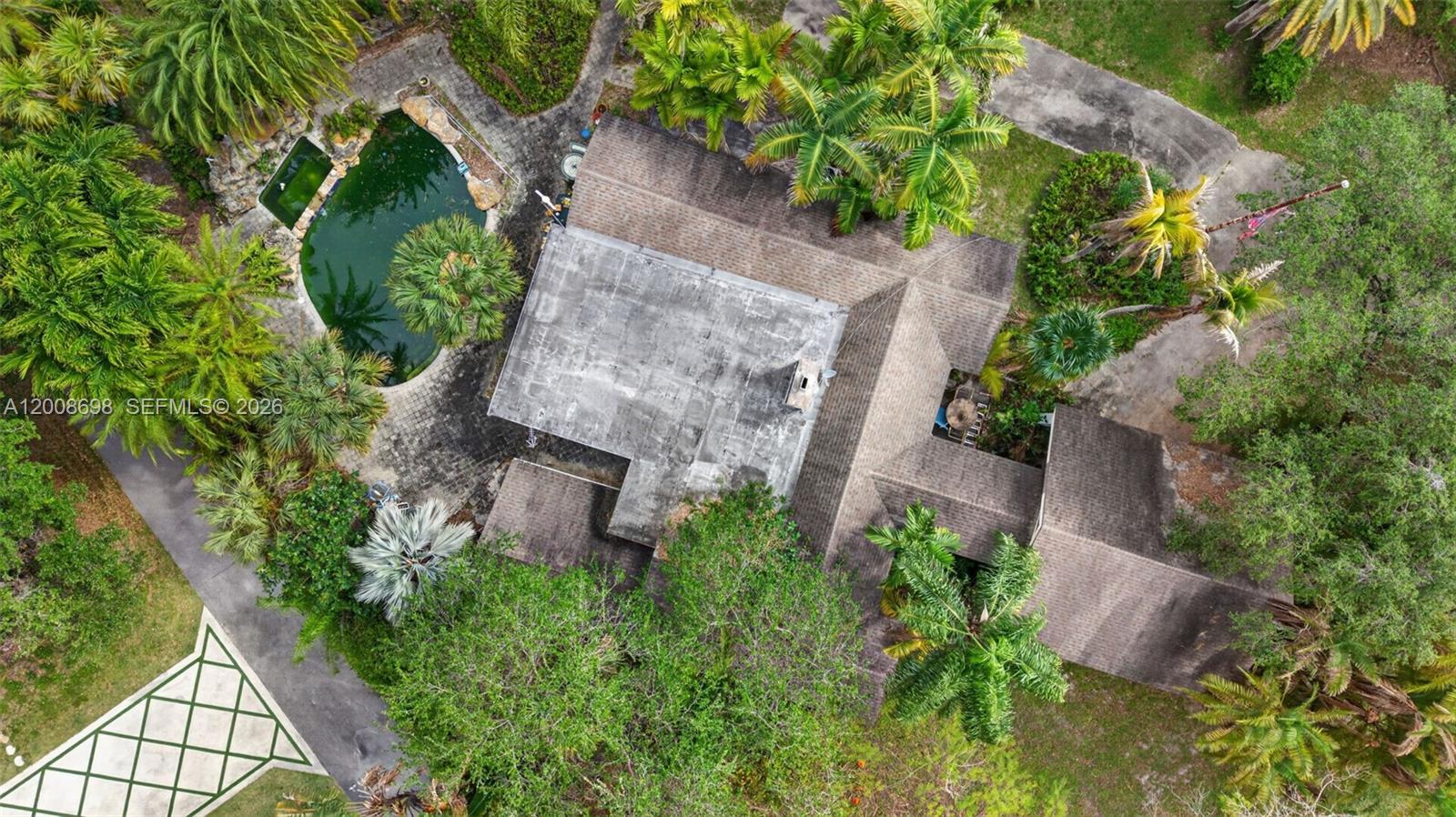 An aerial view shows a house with a flat roof section, shingled roof, and pool — 8339 SW 112th St, Miami FL 33156, MIAMI, FL
