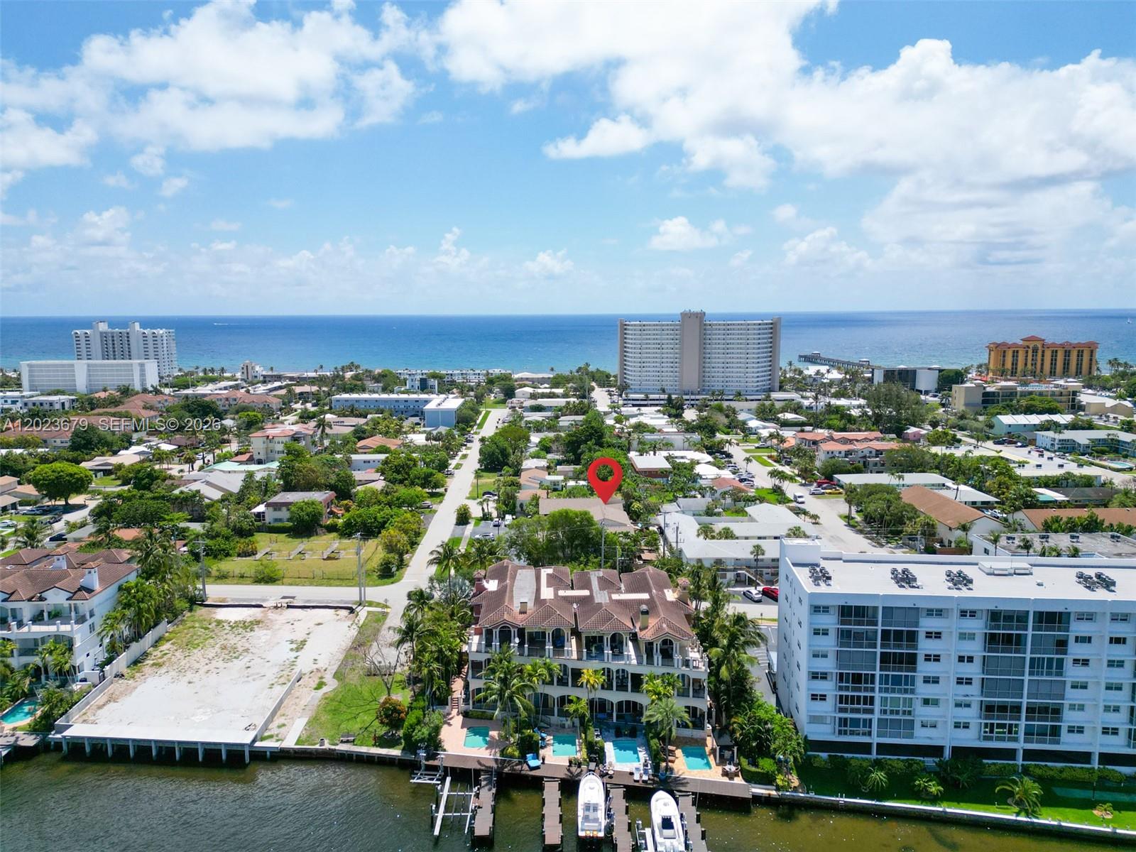 An aerial view shows a waterfront residential area with a red location pin — 1910 NE 5th St # 107, Deerfield Beach FL 33441, DEERFIELD BEACH, FL