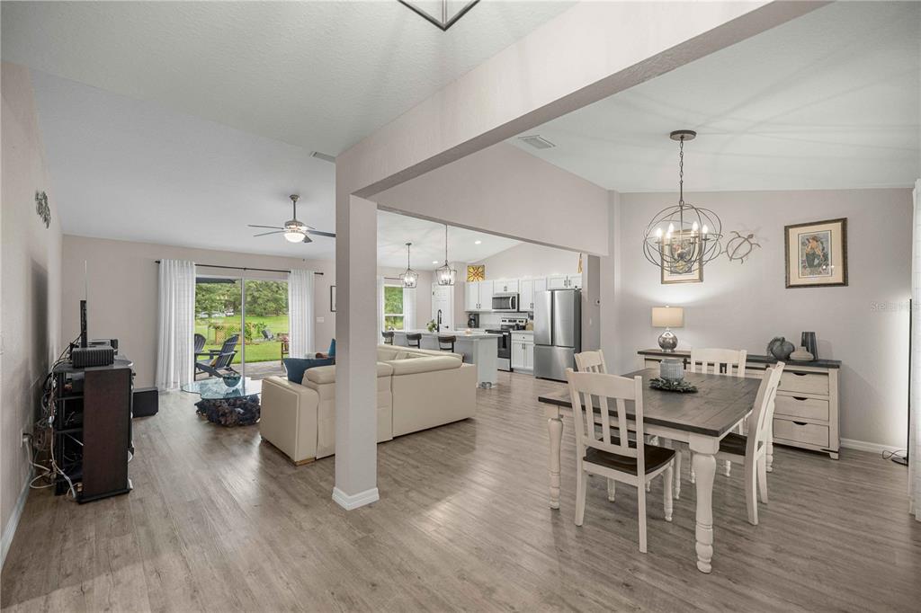 An open-concept living area features a dining space, a kitchen, and a living room — 19855 SW 59TH LANE, DUNNELLON, FL