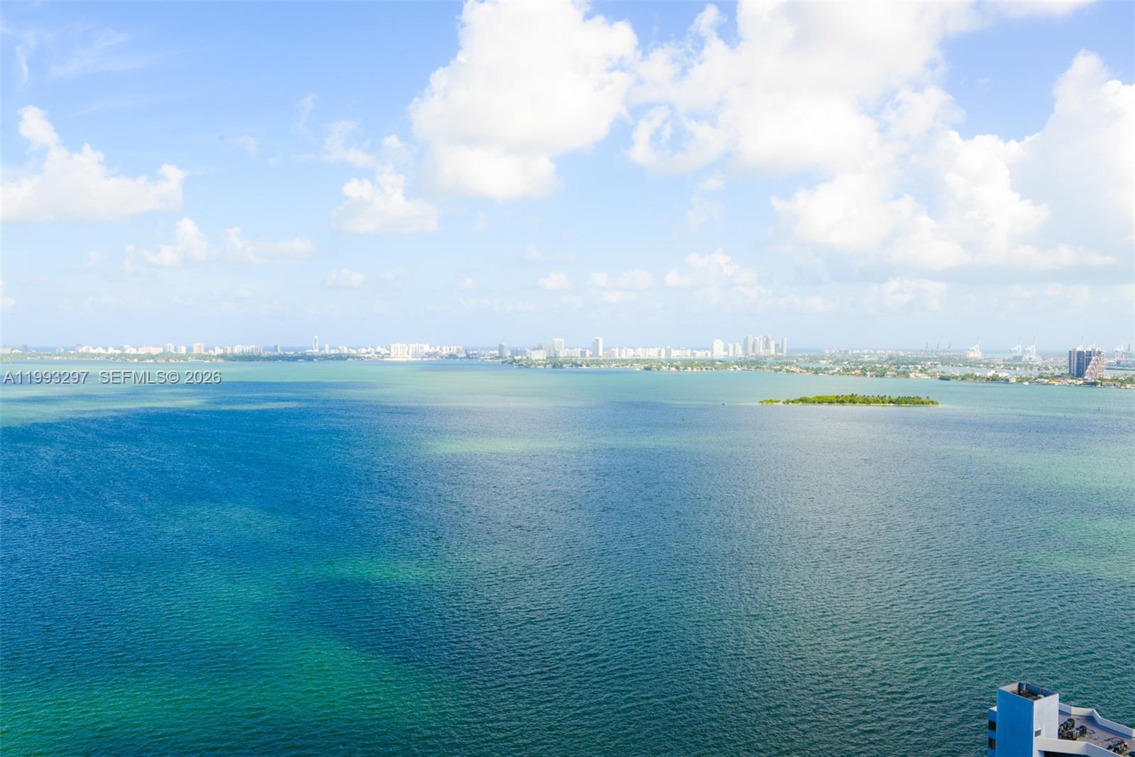 An elevated view of a large body of water with a distant city skyline — 650 NE 32nd St # 2104, Miami FL 33137, MIAMI, FL