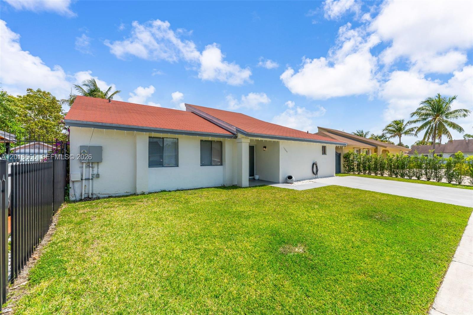 A single-story house with a red roof, white stucco walls, and a front lawn — 12247 SW 203rd St, Miami FL 33177, MIAMI, FL