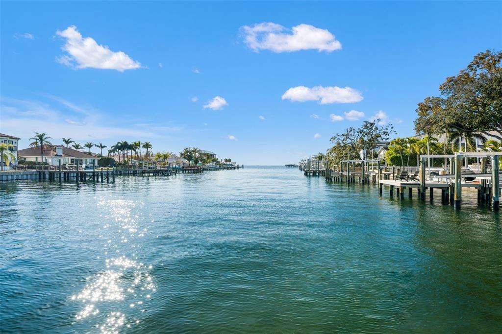 A view looking down a canal lined with residential docks and houses under a blue sky — 2605 S BEACH DRIVE, TAMPA, FL