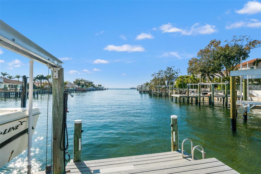 A view from a wooden dock looking out over a canal toward the open water — 2605 S BEACH DRIVE, TAMPA, FL