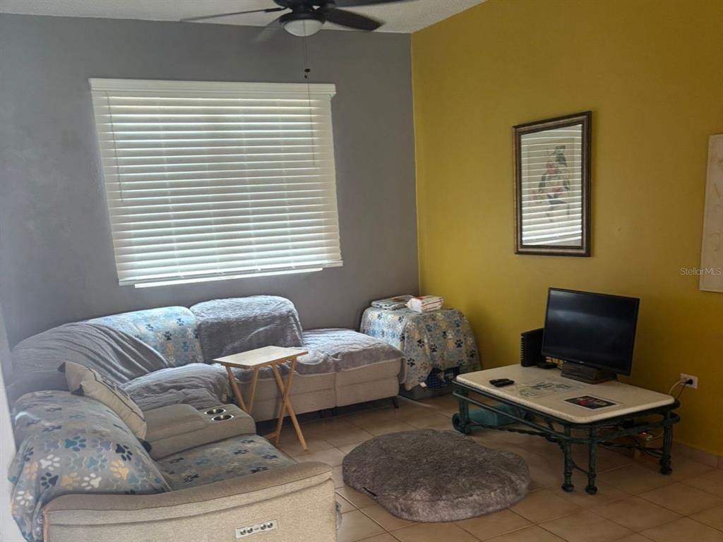 A living room features a sectional sofa, a coffee table with a television, and two-toned walls — 150 SE CANDELERO DRIVE DRIVE UNIT 712, HUMACAO, PR