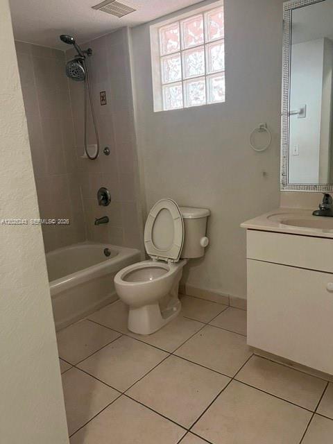 A bathroom features a white toilet, a bathtub with a shower head, and a vanity — 650 Palm Ave # A2, Hialeah FL 33010, HIALEAH, FL