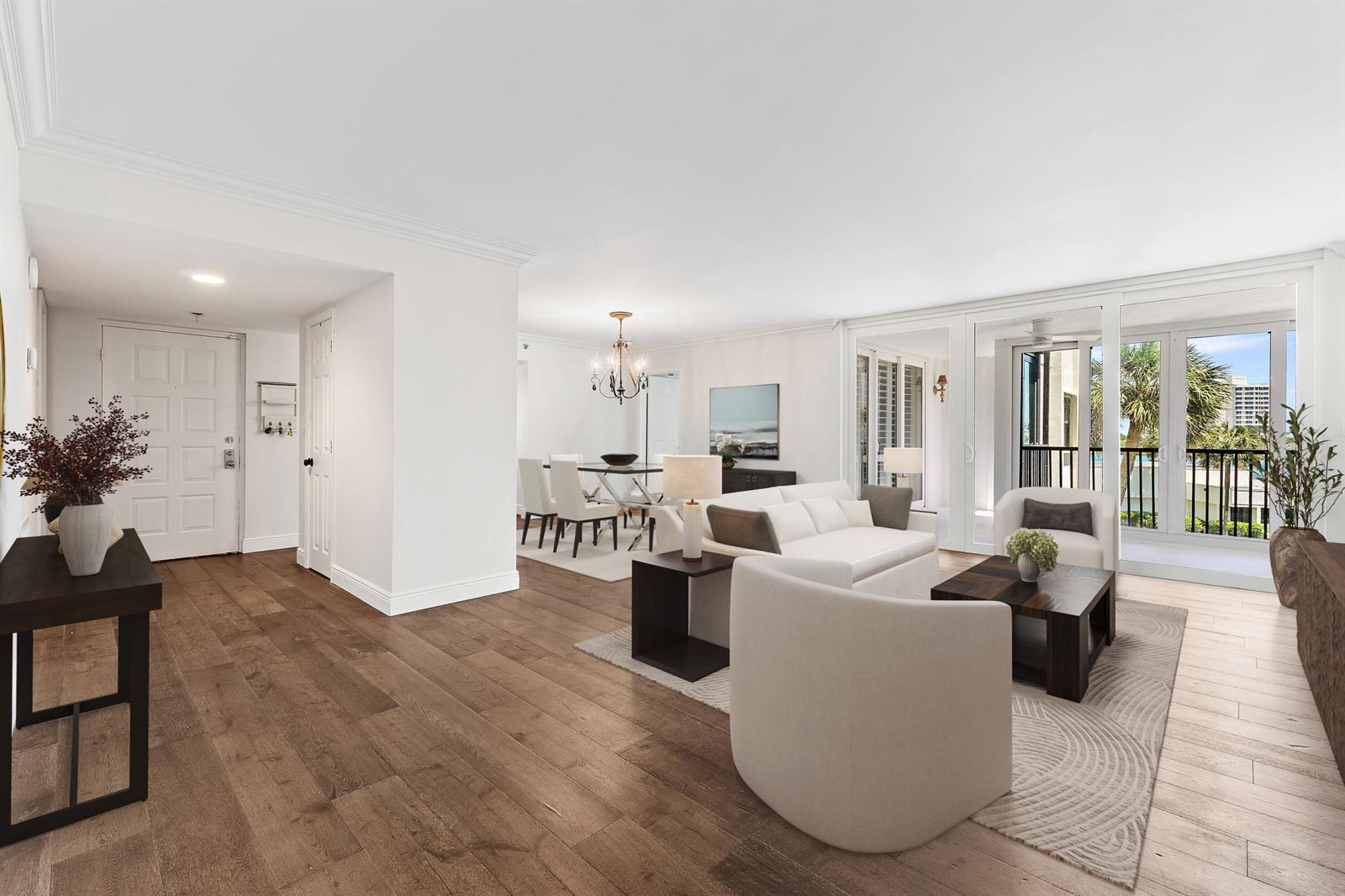 A bright living and dining area with hardwood floors, white furniture, and a balcony view — 19800 Sandpointe Bay Drive # 305, Tequesta FL 33469, TEQUESTA, FL