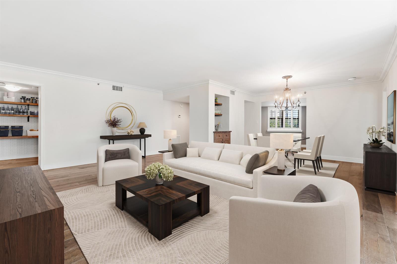 A bright, open-concept living and dining room featuring white walls, hardwood floors, and modern furniture — 19800 Sandpointe Bay Drive # 305, Tequesta FL 33469, TEQUESTA, FL