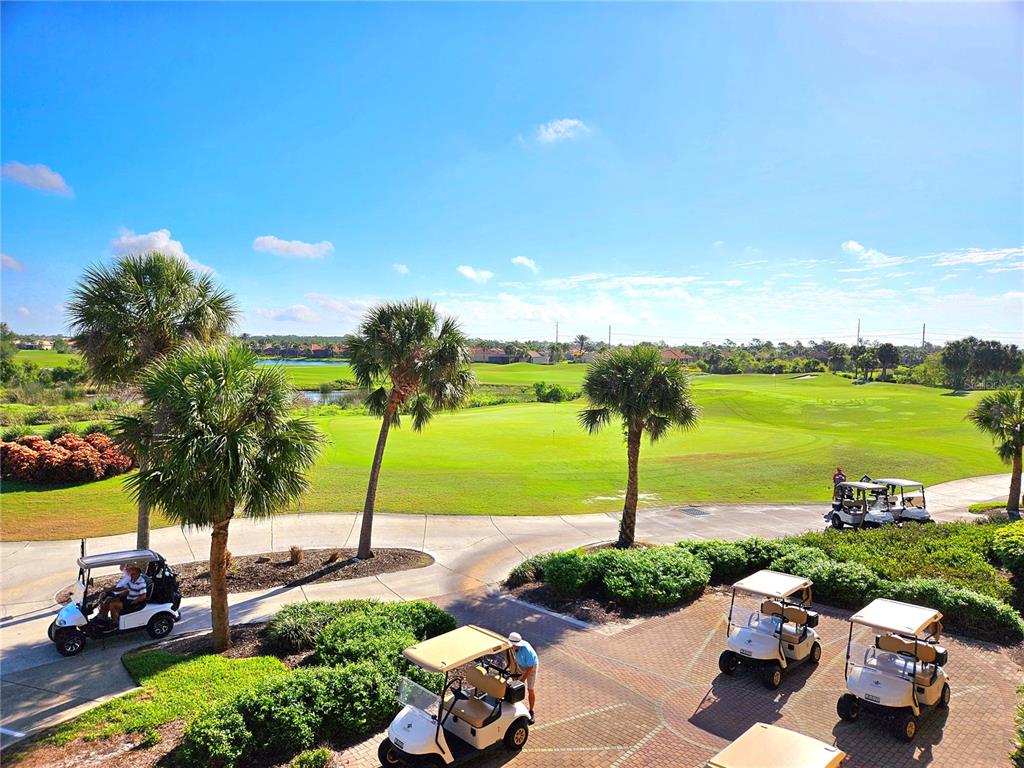 An elevated view shows golf carts parked on a paved area overlooking a golf course — 209 MESTRE PLACE, NORTH VENICE, FL