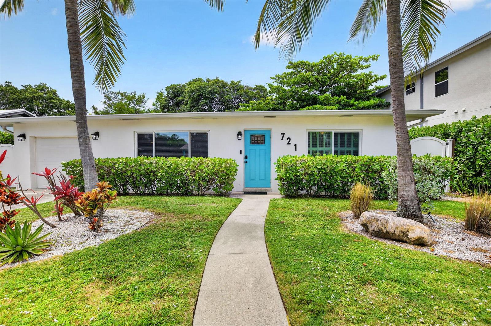 A white single-story house features a bright blue front door and a concrete walkway — 721 NE 8th Avenue, Boynton Beach FL 33435, BOYNTON BEACH, FL