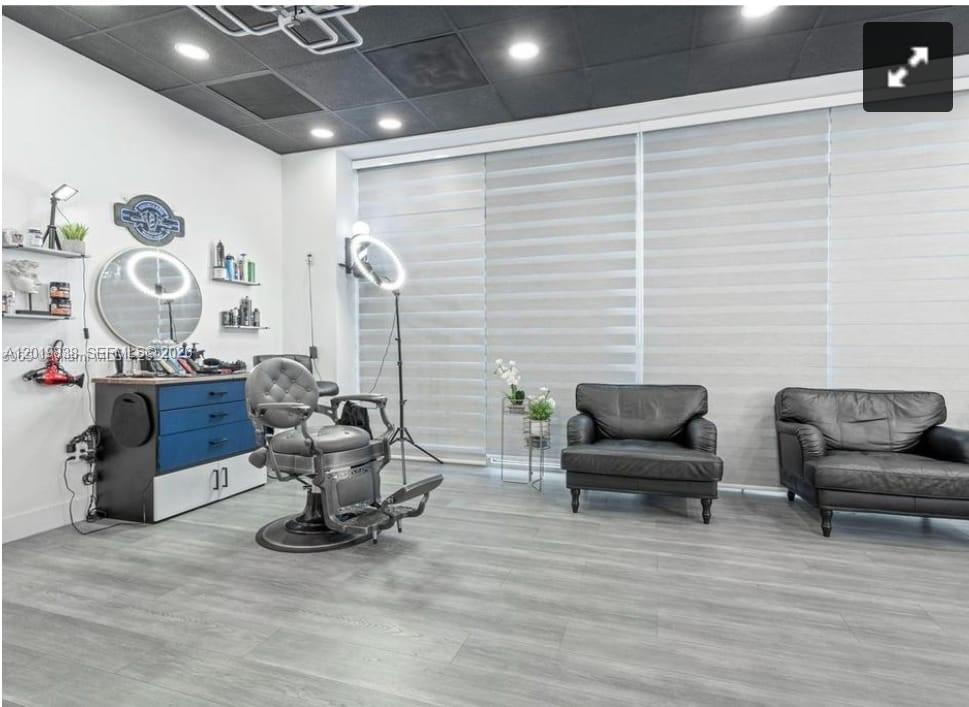 A salon room features a barber chair, a blue storage cabinet, and two black chairs — 2300 W 84th St, Hialeah FL 33016, HIALEAH, FL