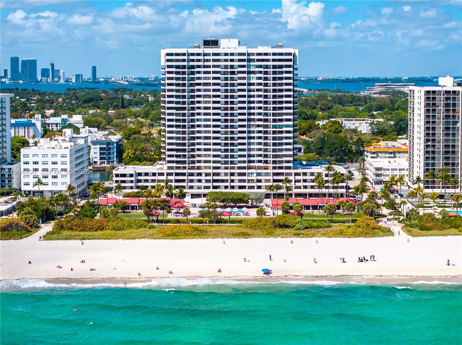 An aerial view of a tall beachfront condominium building with a pool and sandy beach — 2555 Collins Ave # 2402, Miami Beach FL 33140, MIAMI BEACH, FL
