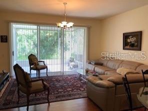 A living room features a beige sectional sofa, two armchairs, and a large area rug — 948 VISTA CAY COURT, BRANDON, FL