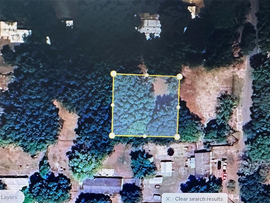 This is an aerial map view showing a rectangular property boundary highlighted in yellow — 22-26-21-0010-00000-0062, ZEPHYRHILLS, FL