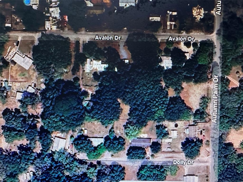 This is an aerial map view of a residential neighborhood intersection — 22-26-21-0010-00000-0062, ZEPHYRHILLS, FL