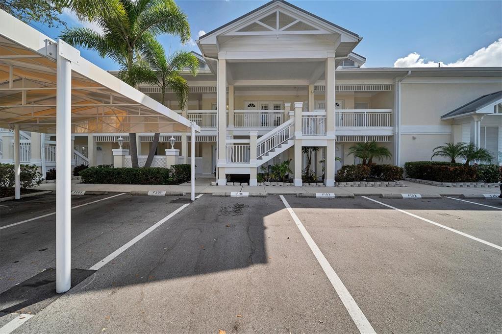 A two-story residential building with a covered parking area and a central outdoor staircase — 3401 54TH DRIVE W UNIT 202, BRADENTON, FL