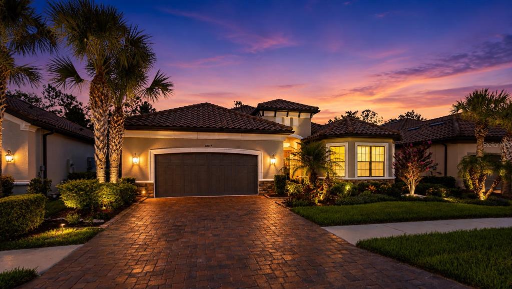 A single-story house with a tile roof, a two-car garage, and a landscaped front yard — 20117 UMBRIA HILL DRIVE, TAMPA, FL