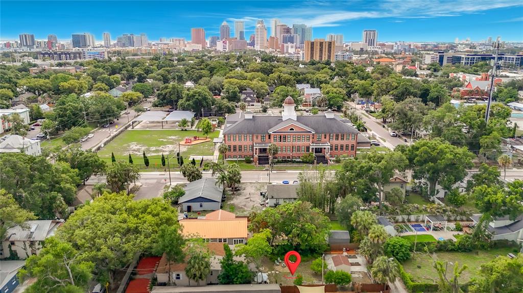 An aerial view shows a residential property with a red location pin near a school — 2708 N JEFFERSON STREET, TAMPA, FL