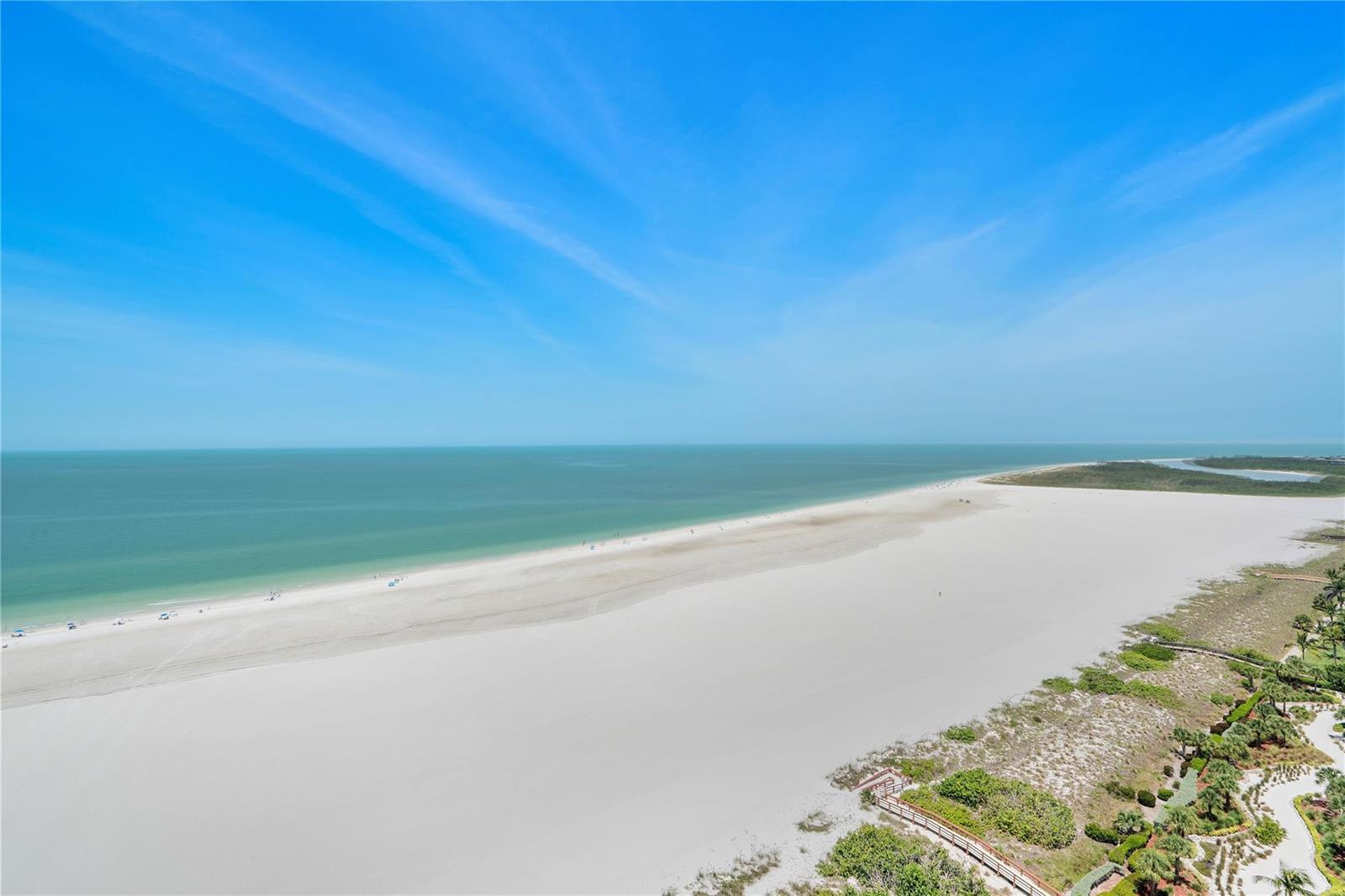 An aerial view of a wide sandy beach meeting the ocean under a blue sky — 58 N Collier Boulevard # 2108, Marco Island FL 34145, MARCO ISLAND, FL
