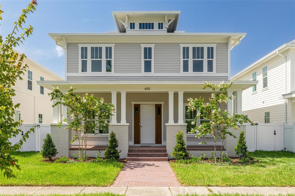 A two-story house with light gray siding, a front porch, and a brick walkway — 455 47TH AVENUE N, ST PETERSBURG, FL
