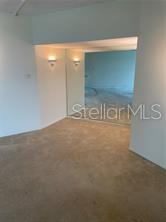 A carpeted room features a mirrored wall section and two wall-mounted light fixtures — 435 S GULFSTREAM AVENUE UNIT 906, SARASOTA, FL