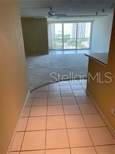A tiled entryway leads into a carpeted living area with floor-to-ceiling windows — 435 S GULFSTREAM AVENUE UNIT 906, SARASOTA, FL