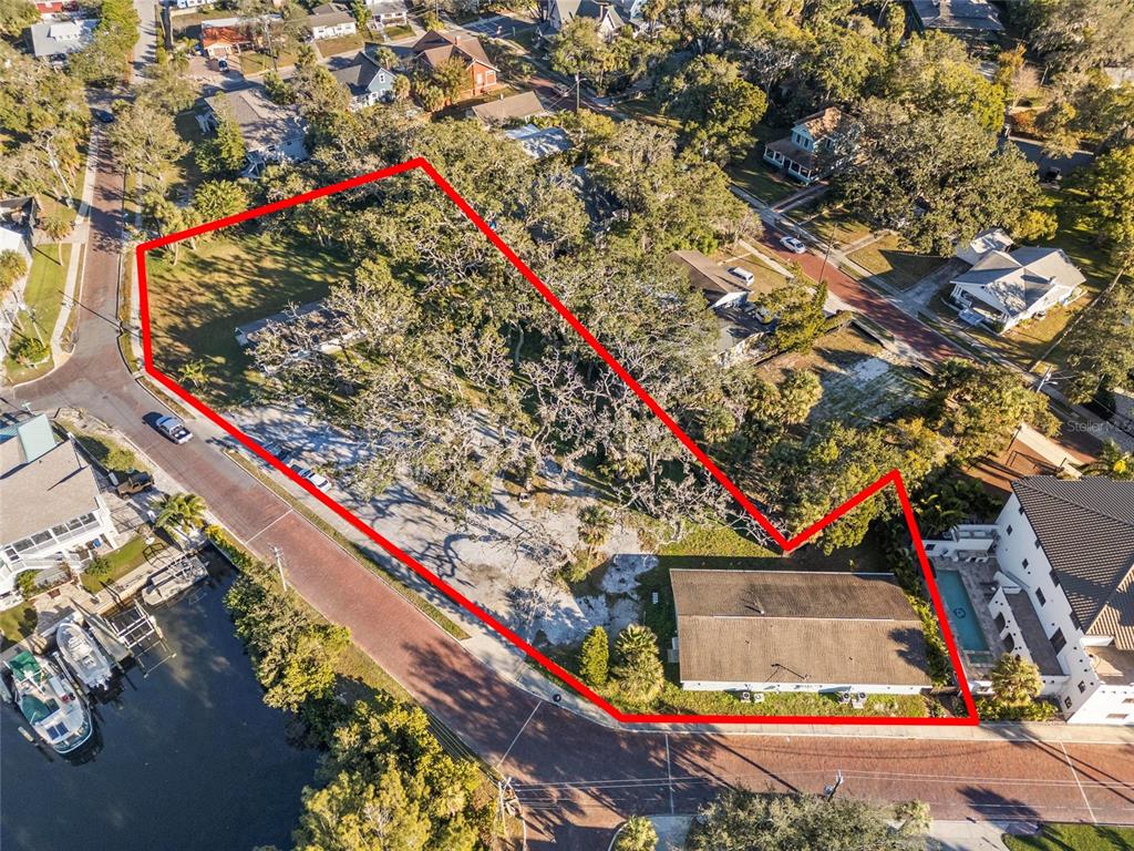 An aerial view shows a residential lot with a house and a red boundary outline — 404 CANAL STREET, TARPON SPRINGS, FL