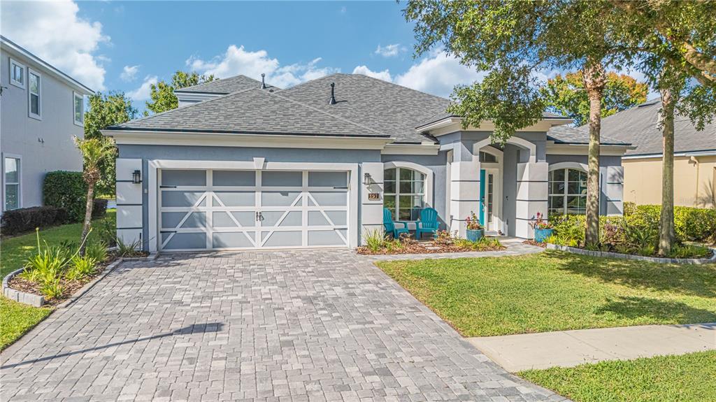 A single-story house with a gray exterior, a two-car garage, and a paved driveway — 191 S ARABELLA WAY, ST JOHNS, FL