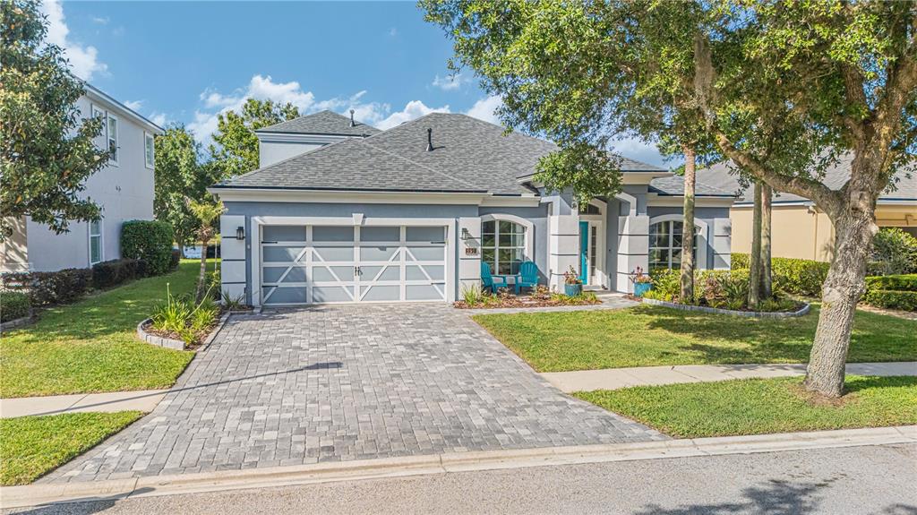A single-story house with a gray exterior, a paved driveway, and a two-car garage — 191 S ARABELLA WAY, ST JOHNS, FL