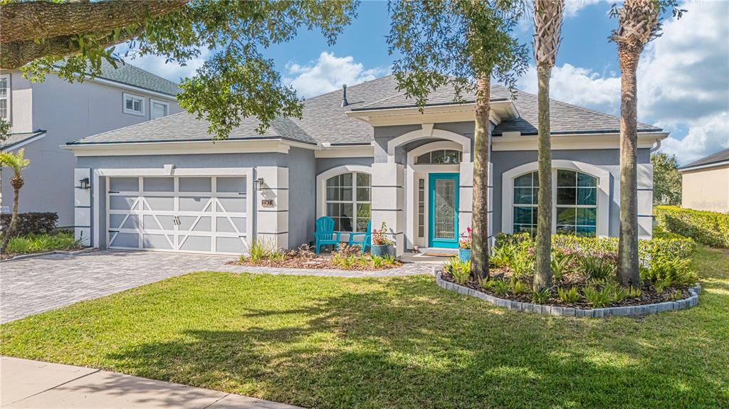 A single-story gray house with a two-car garage, turquoise front door, and palm trees — 191 S ARABELLA WAY, ST JOHNS, FL