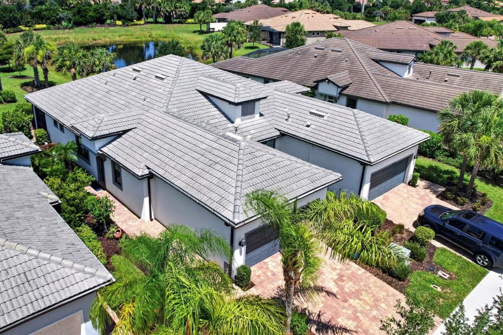 An aerial view shows a house with a gray tiled roof and a paved driveway — 12287 MYRTLE BAY COURT, SARASOTA, FL