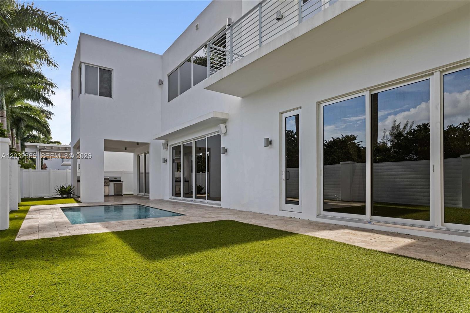 A modern white two-story house features a swimming pool, patio, and artificial turf lawn — 10296 NW 74th Terrace, Doral FL 33178, DORAL, FL