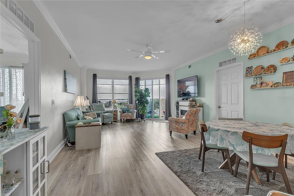 A living and dining area features light wood flooring, a ceiling fan, and wall decor — 2801 S RIDGEWOOD AVENUE UNIT 502, SOUTH DAYTONA, FL