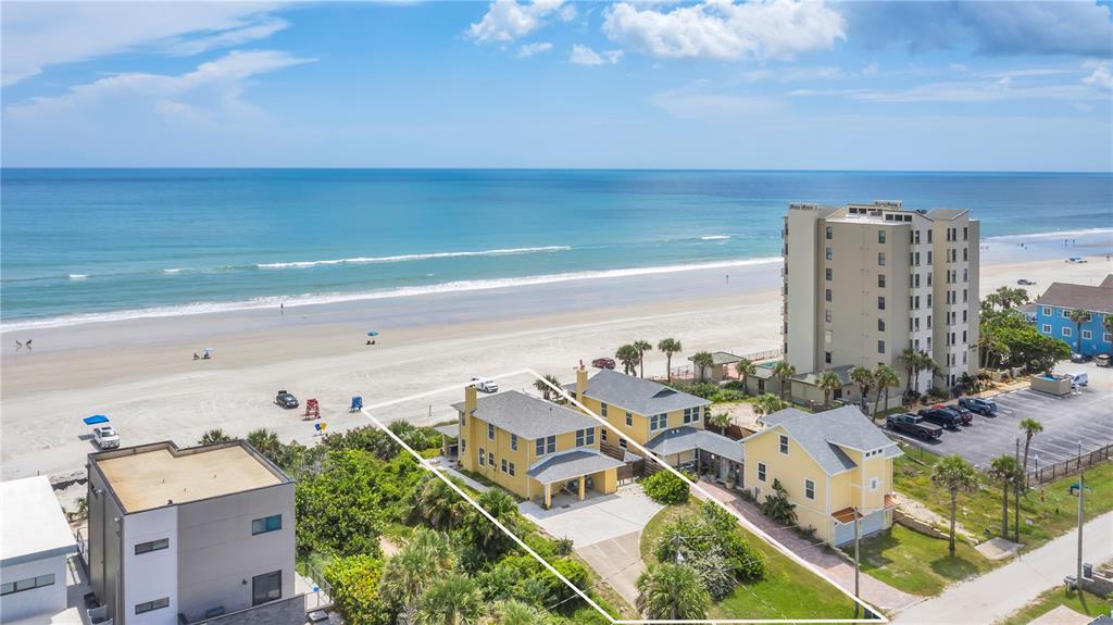 An aerial view shows a yellow beach house with a white outline on the property — 2101 HILL STREET, NEW SMYRNA BEACH, FL