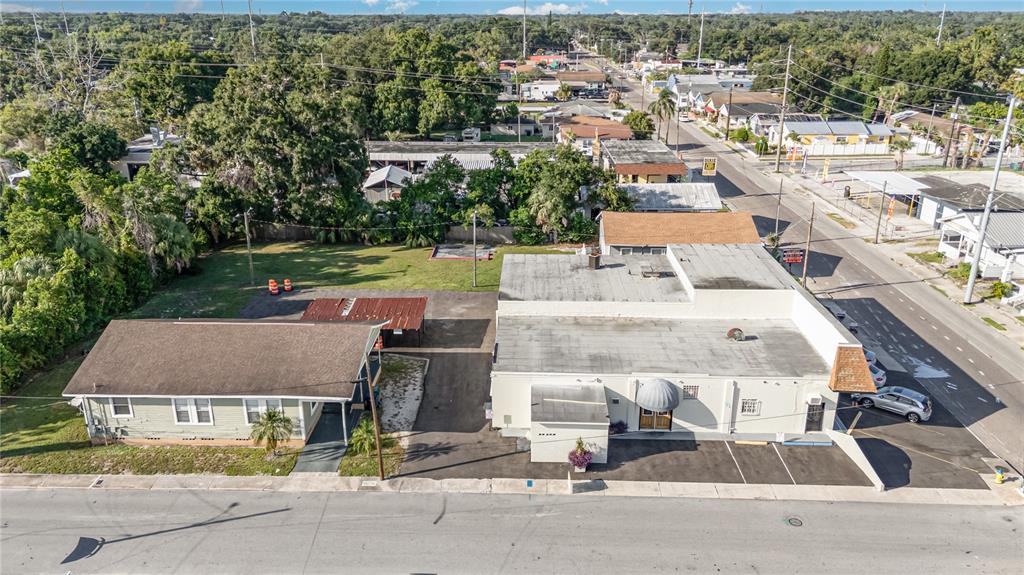An aerial view shows a light green house, a commercial building, and a parking lot — 3416 N 15TH STREET, TAMPA, FL