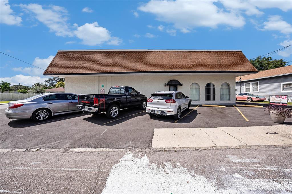 A single-story commercial building with a brown shingled roof and a paved parking lot — 3416 N 15TH STREET, TAMPA, FL