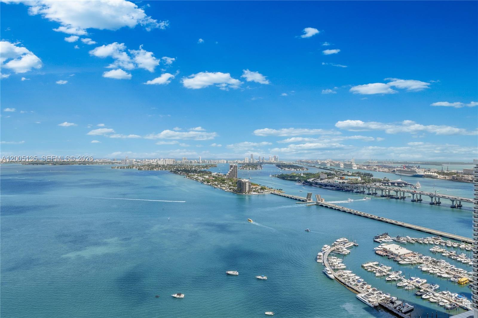 An aerial view shows a marina, a bridge, and islands surrounded by blue water — 488 NE 18th St # 3715, Miami FL 33132, MIAMI, FL
