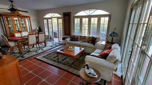 A living and dining area features tile floors, a wooden hutch, and large arched windows — 27 SAN MIGUEL, HUMACAO, PR
