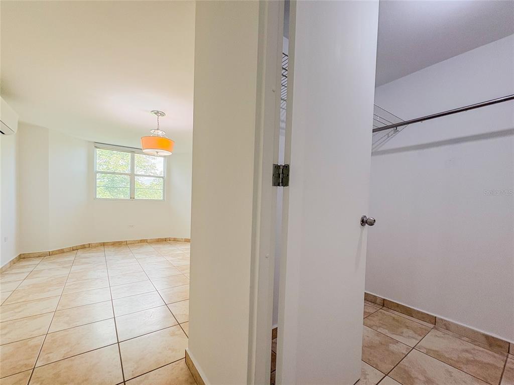 A tiled room with a window and light fixture is visible next to a closet — 59 CLL UNION COND. HILLSVIEW PLAZA UNIT 107, GUAYNABO, PR