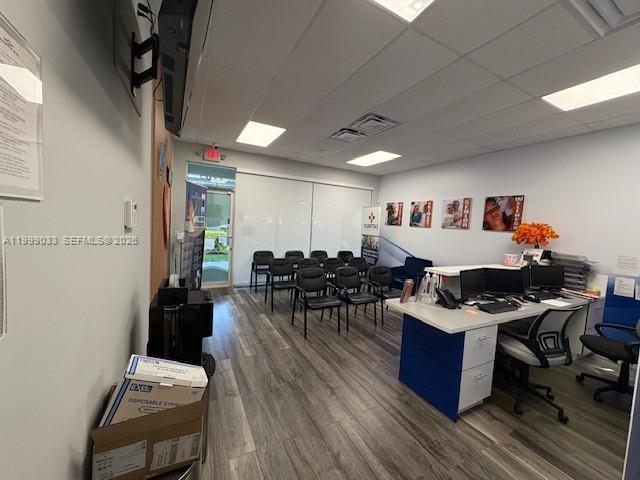 An office space features a reception desk, rows of chairs, and wood-look flooring — 2701 SW 142nd Ave # 2705, Miami FL 33175, MIAMI, FL