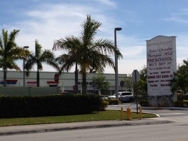 A street-level view of a shopping plaza with palm trees and a tall directory sign — 2701 SW 142nd Ave # 2705, Miami FL 33175, MIAMI, FL