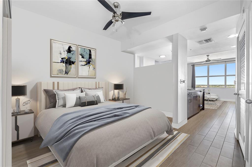 A bedroom with a bed and nightstands opens into a kitchen and living area — 1120 E KENNEDY BOULEVARD UNIT 1417, TAMPA, FL