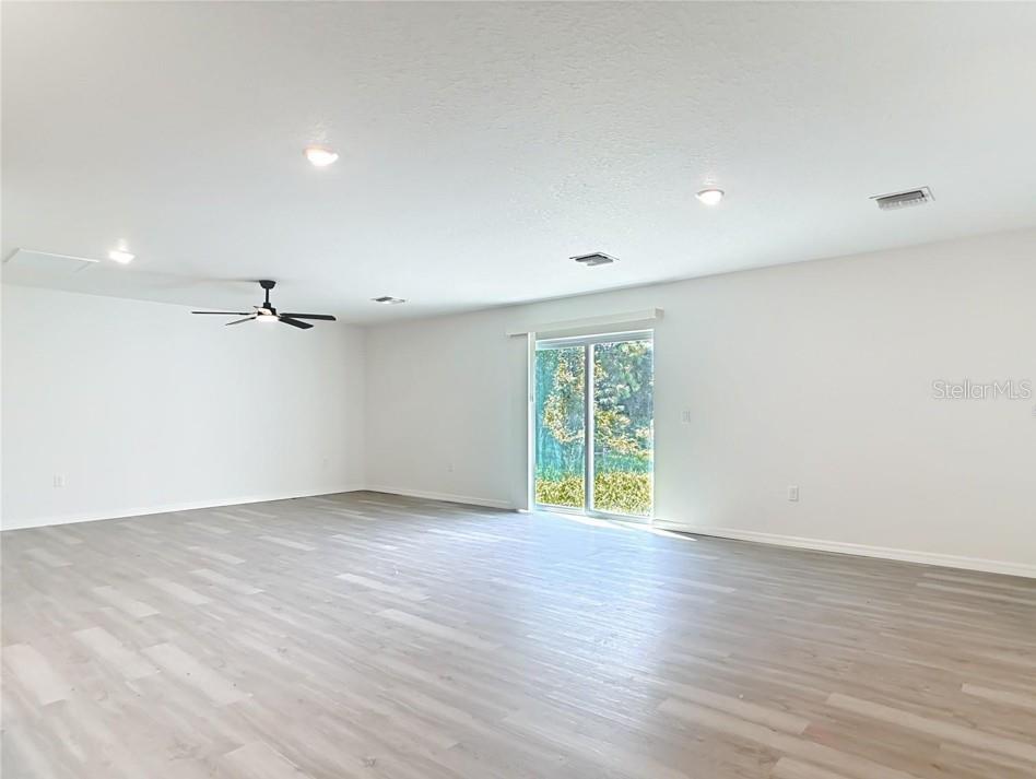 A single-story house with a white exterior, a two-car garage, and a concrete driveway — 3716 5TH STREET W, LEHIGH ACRES, FL