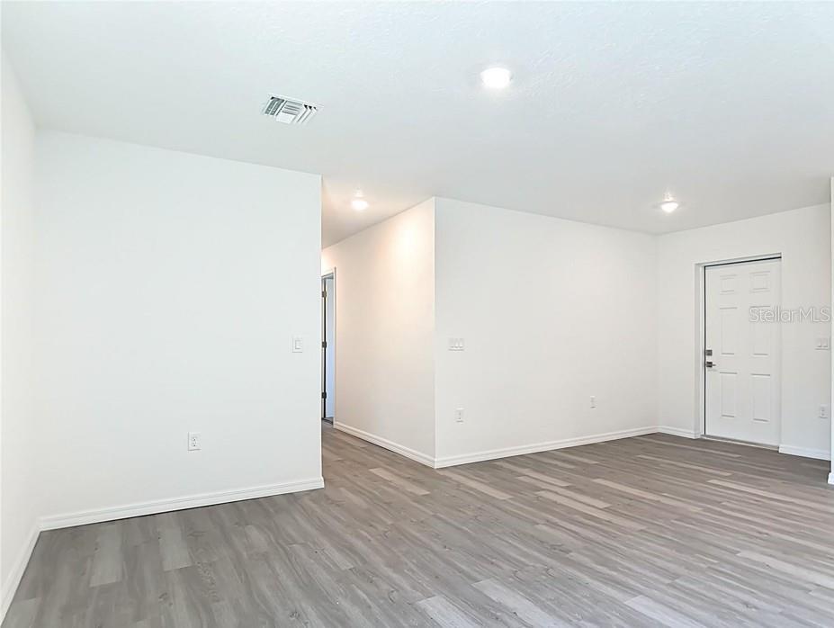 A single-story house with a white exterior, a two-car garage, and a concrete driveway — 3716 5TH STREET W, LEHIGH ACRES, FL