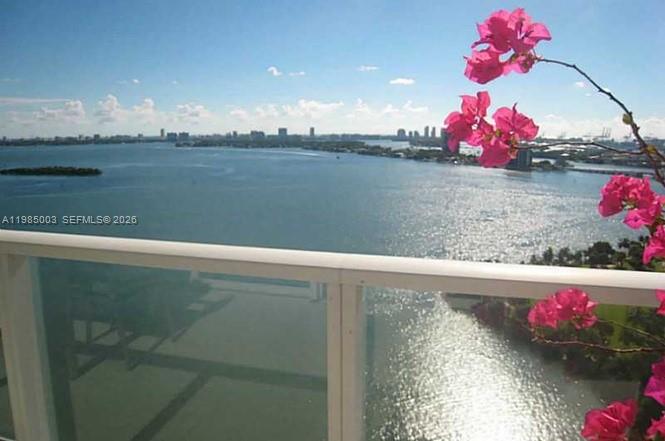 A balcony view overlooks a large body of water with a city skyline in the distance — 2020 N Bayshore Dr # 2204, Miami FL 33137, MIAMI, FL