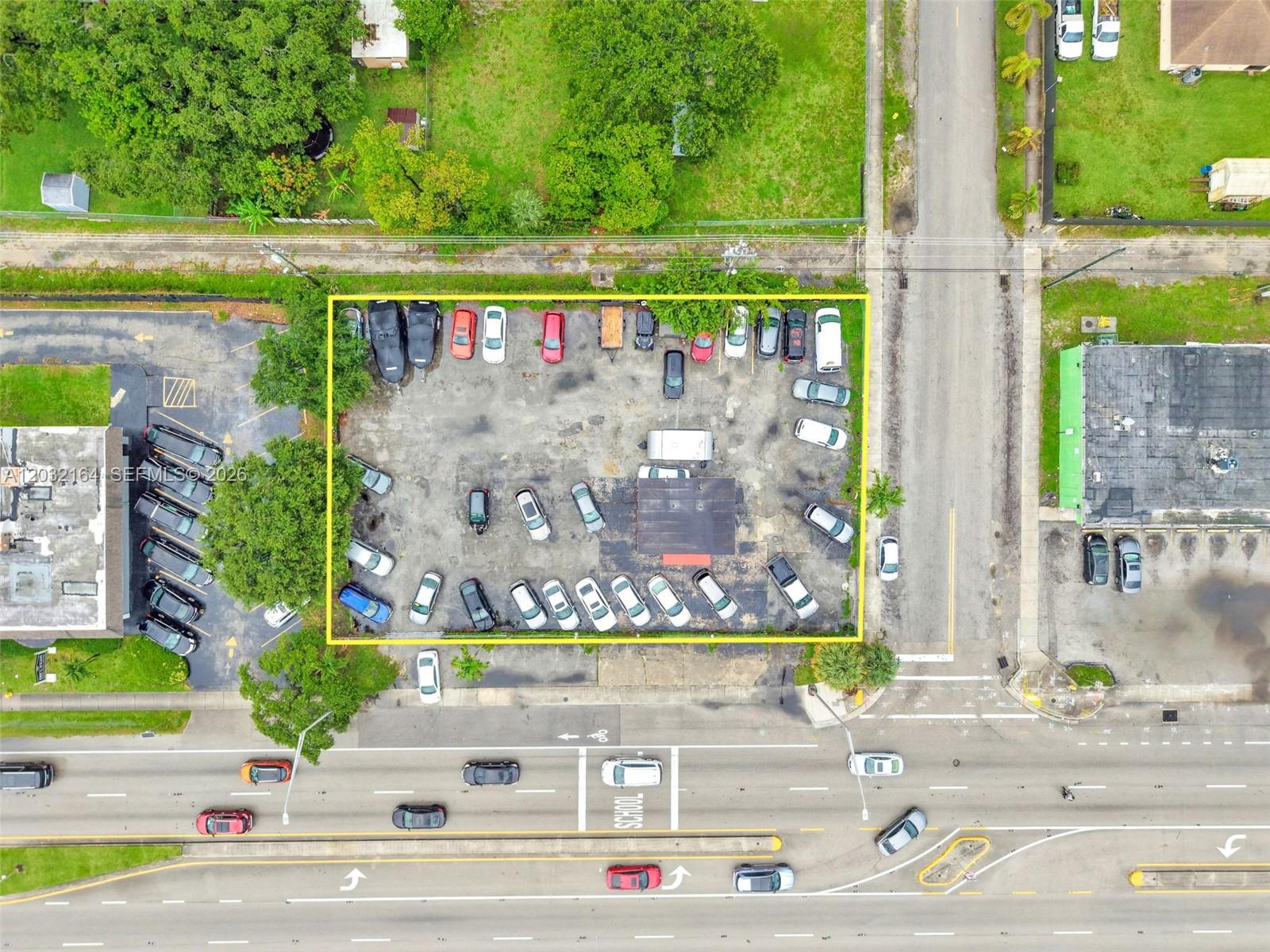 An aerial view shows a rectangular parking lot filled with numerous vehicles — 4601 W Hallandale Beach Blvd, Hollywood FL 33023, HOLLYWOOD, FL