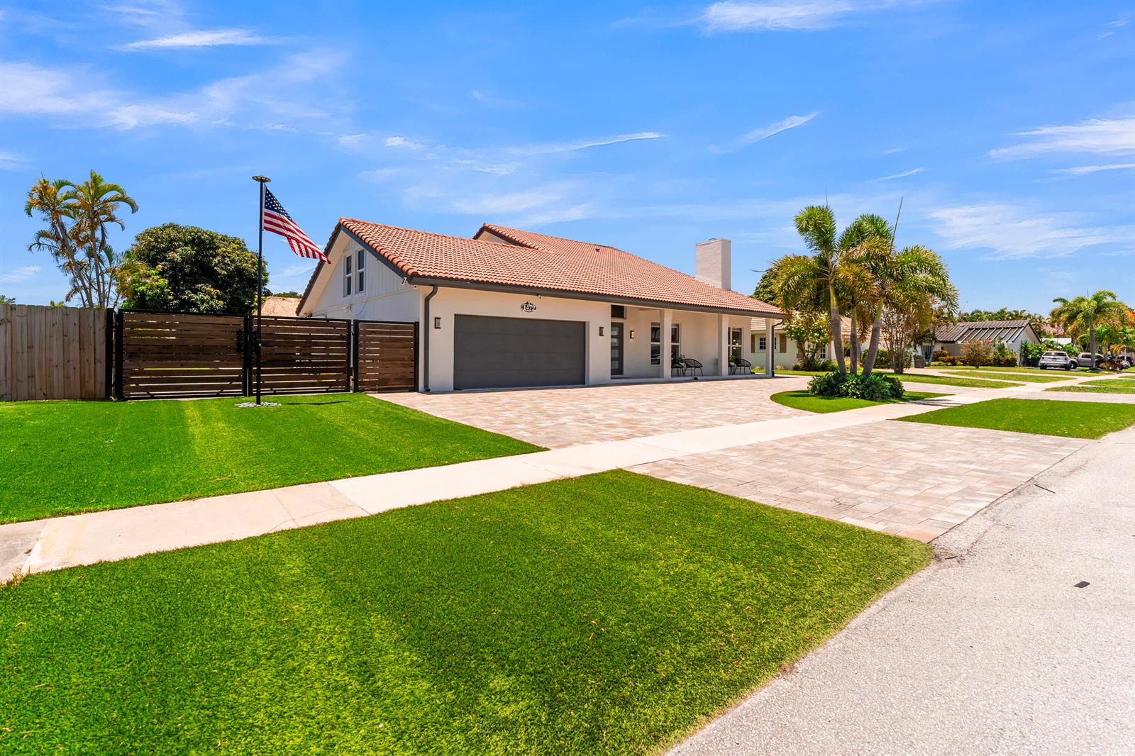 A single-story house with a tiled roof, gray garage door, and a paved driveway — 1472 SW 13th Street, Boca Raton FL 33486, BOCA RATON, FL