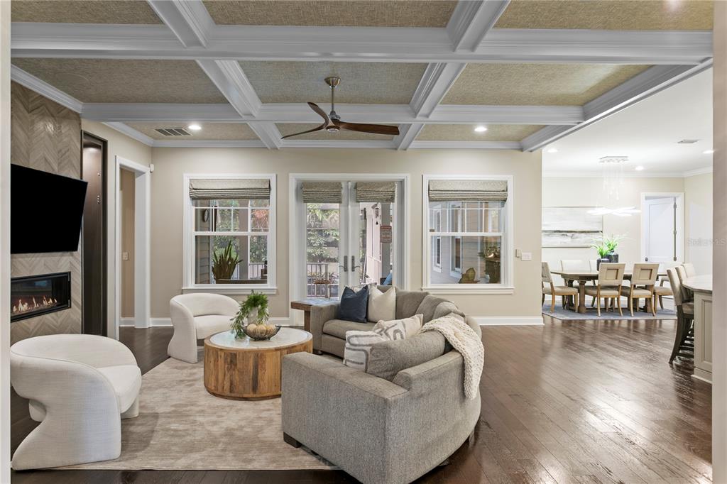 A living room features a coffered ceiling, a fireplace, and a curved sectional sofa — 5016 W EVELYN DRIVE, TAMPA, FL
