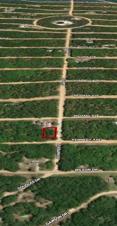This aerial map shows a vacant, rectangular lot outlined in red along a dirt road — LOT 18 KENNEDY AVENUE, INTERLACHEN, FL